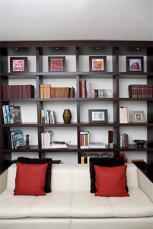 Couch in front of shelves in a living room Stock Photo - Premium Royalty-Free, Code: 625-01743907