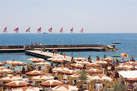 Tourists at a cafe on the beach, Monte Carlo, Monaco Stock Photo - Premium Royalty-Free, Code: 625-01750443