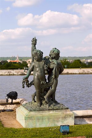 Statues near a pond in a formal garden, Palace of Versailles, Versailles, France Stock Photo - Premium Royalty-Free, Code: 625-01750582