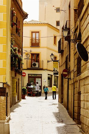 people walking on streets in spain - Buildings along a street, Toledo, Spain Stock Photo - Premium Royalty-Free, Code: 625-01750716