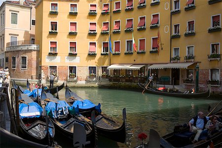 docked gondola buildings - Gondolas docked in a canal near buildings, Venice, Italy Stock Photo - Premium Royalty-Free, Code: 625-01750765