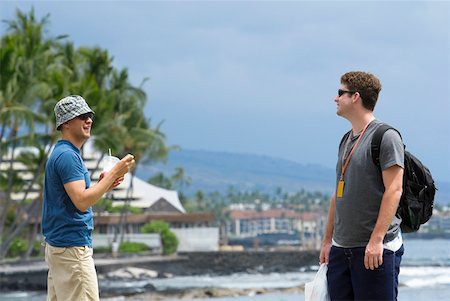 Two young men standing on the beach, Kona, Big Island, Hawaii Islands, USA Fotografie stock - Premium Royalty-Free, Codice: 625-01751193