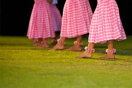 Low section view of four women hula dancing in a lawn Stock Photo - Premium Royalty-Free, Code: 625-01751262
