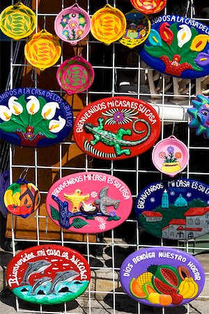 Ceramics hanging on a chain- linked fence, Cancun, Mexico Stock Photo - Premium Royalty-Free, Code: 625-01751835