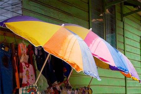 simsearch:625-01751908,k - Three umbrellas with clothes in a clothing store, Coxen Hole, Roatan, Bay Islands, Honduras Foto de stock - Royalty Free Premium, Número: 625-01751961