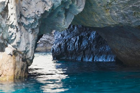 Close-up of a natural arch in a rock formation, Faraglioni Rocks, Capri, Campania, Italy Stock Photo - Premium Royalty-Free, Code: 625-01752031