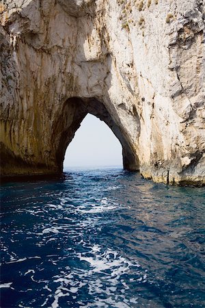 Natural arch in a rock formation, Faraglioni Rocks, Capri, Campania Italy Stock Photo - Premium Royalty-Free, Code: 625-01752054