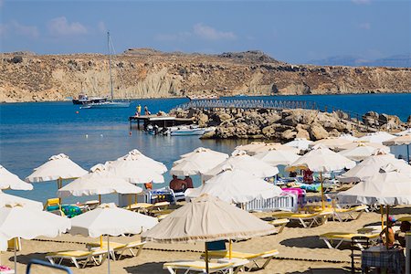 Beach umbrellas on the beach, Lindos, Rhodes, Dodecanese Islands, Greece Stock Photo - Premium Royalty-Free, Code: 625-01752167