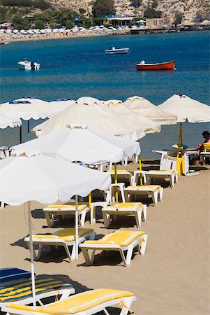 Lounge chairs and beach umbrellas on the beach, Lindos, Rhodes, Dodecanese Islands, Greece Stock Photo - Premium Royalty-Free, Code: 625-01752210