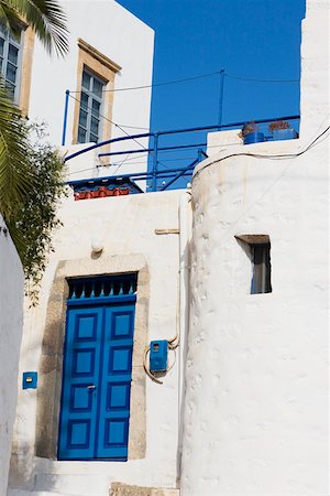 Low angle view of a closed door of a building, Patmos, Dodecanese Islands, Greece Stock Photo - Premium Royalty-Free, Code: 625-01752660