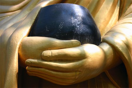 Close-up of a statue holding a bowl, Vientiane, Laos Fotografie stock - Premium Royalty-Free, Codice: 625-01752900