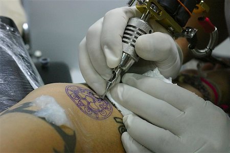 simsearch:625-01753059,k - Close-up of a person's hands tattooing on a person's arm, Bangkok, Thailand Stock Photo - Premium Royalty-Free, Code: 625-01752986
