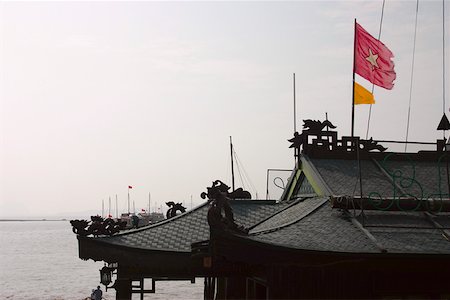 Flag fluttering on a pagoda, Halong Bay, Vietnam Foto de stock - Sin royalties Premium, Código: 625-01753098