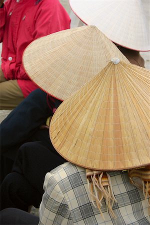 Close-up of three people wearing asian style conical hats, Hanoi, Vietnam Stock Photo - Premium Royalty-Free, Code: 625-01753093