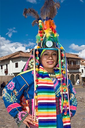 south american headdress feather - Portrait of a young woman wearing a traditional clothing and standing with arms akimbo, Peru Stock Photo - Premium Royalty-Free, Code: 625-01753516