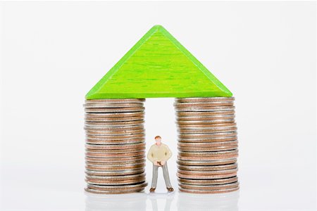 stacks of money and coins - Figurine between two stacks of coins Stock Photo - Premium Royalty-Free, Code: 625-02265950
