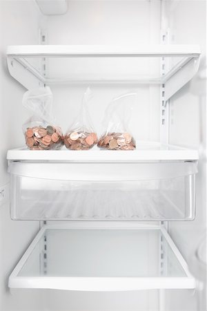 Three plastic bags of coins in a refrigerator Stock Photo - Premium Royalty-Free, Code: 625-02265967
