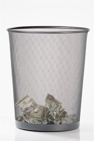 Close-up of US dollar bills in a garbage bin Stock Photo - Premium Royalty-Free, Code: 625-02266048