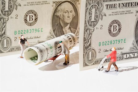 dollar grow - Figurines of manual workers with US dollar bills Stock Photo - Premium Royalty-Free, Code: 625-02266041