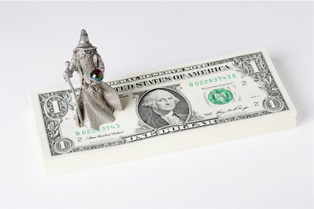 Figurine of a fortune teller on US paper currency Stock Photo - Premium Royalty-Free, Code: 625-02266053