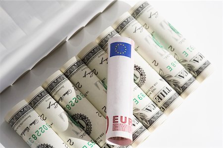 rolled money - European union euro note on rolls of US paper currency Stock Photo - Premium Royalty-Free, Code: 625-02266094