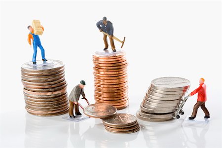 stacks of money and coins - Figurines of manual workers with stacks of coins Stock Photo - Premium Royalty-Free, Code: 625-02266113