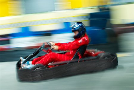 sport car speed - Side profile of a person go- carting on a motor racing track Stock Photo - Premium Royalty-Free, Code: 625-02266398