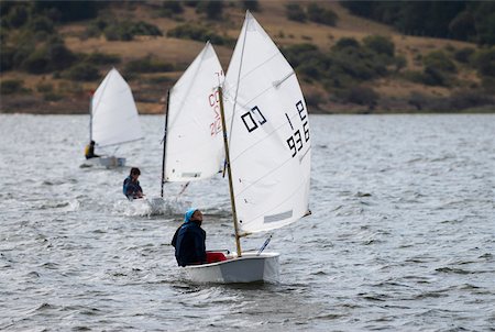 simsearch:625-01098257,k - Three people participating in a sailboat race Foto de stock - Sin royalties Premium, Código: 625-02266429