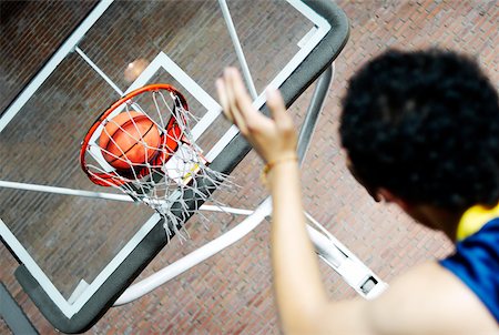 Rear view of a man playing basketball Stock Photo - Premium Royalty-Free, Code: 625-02266436