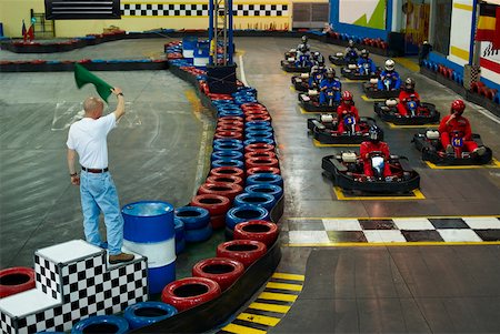 sports car and person - High angle view of go-cart racer at starting line with a man waving a flag Foto de stock - Sin royalties Premium, Código: 625-02266458