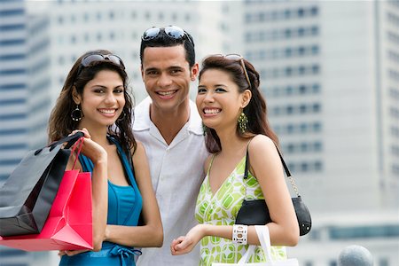 simsearch:625-02267530,k - Portrait of a mid adult man and two young women smiling Stock Photo - Premium Royalty-Free, Code: 625-02266521