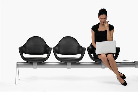 Businesswoman sitting on a bench and using a laptop Stock Photo - Premium Royalty-Free, Code: 625-02266547