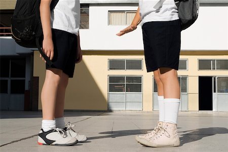 door education - Low section view of two schoolboys standing in front of a school building Stock Photo - Premium Royalty-Free, Code: 625-02266555