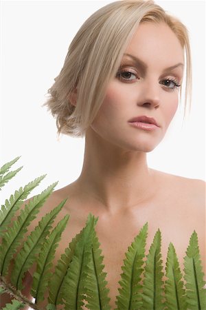 simsearch:625-02267557,k - Portrait of a young woman holding a fern Stock Photo - Premium Royalty-Free, Code: 625-02266574