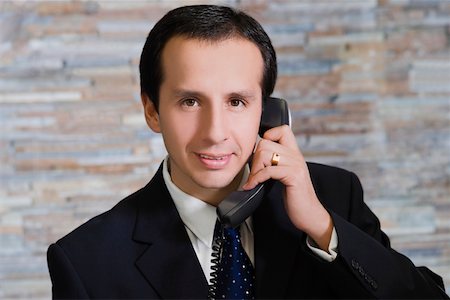 european hotel receptionist - Close-up of a mature man talking on the phone Stock Photo - Premium Royalty-Free, Code: 625-02266722