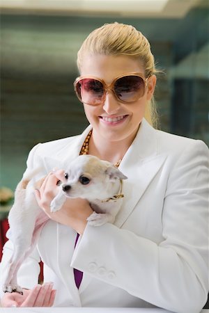 simsearch:625-00849435,k - Businesswoman holding a puppy and smiling Stock Photo - Premium Royalty-Free, Code: 625-02266750