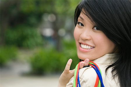 simsearch:625-02266783,k - Portrait of a young woman carrying shopping bags and smiling Stock Photo - Premium Royalty-Free, Code: 625-02266793