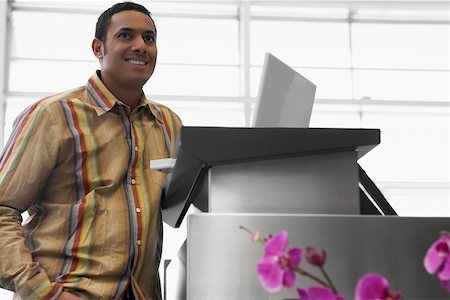 Mid adult man standing at an airport with a laptop Stock Photo - Premium Royalty-Free, Code: 625-02266929