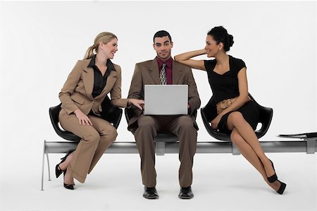 smile group white background - Businessman using a laptop and two businesswomen sitting beside him Stock Photo - Premium Royalty-Free, Code: 625-02266973