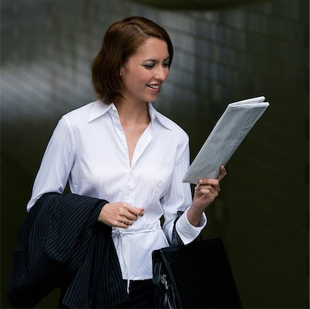 simsearch:625-02929093,k - Close-up of a businesswoman reading a newspaper and smiling Stock Photo - Premium Royalty-Free, Code: 625-02267061
