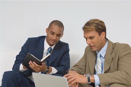 Two businessmen looking at a laptop and having a discussion Stock Photo - Premium Royalty-Free, Code: 625-02267078