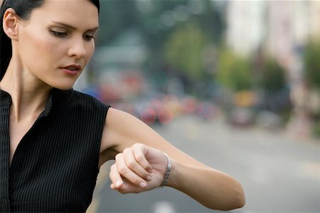 Close-up of a businesswoman checking the time Stock Photo - Premium Royalty-Free, Code: 625-02267071