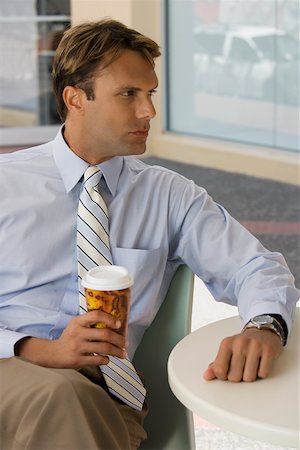 executive man hot - Businessman holding a coffee cup and thinking Stock Photo - Premium Royalty-Free, Code: 625-02267141