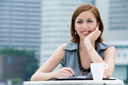 Portrait of a businesswoman sitting at a sidewalk cafe Stock Photo - Premium Royalty-Free, Code: 625-02267160