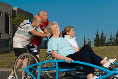 simsearch:625-02932402,k - Two senior women sitting on a quadracycle and two senior men pushing it Stock Photo - Premium Royalty-Free, Code: 625-02267221