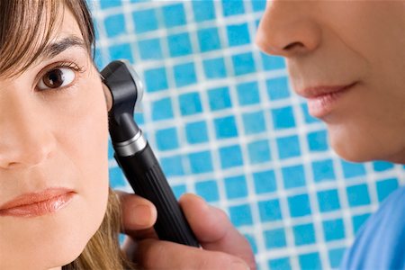 Close-up of a male doctor examining a mature woman's ear Stock Photo - Premium Royalty-Free, Code: 625-02267238