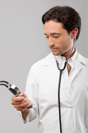 simsearch:700-00022316,k - Male doctor holding a blood pressure gauge Stock Photo - Premium Royalty-Free, Code: 625-02267286