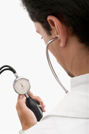 simsearch:700-00022316,k - Rear view of a male doctor holding a blood pressure gauge Stock Photo - Premium Royalty-Free, Code: 625-02267304