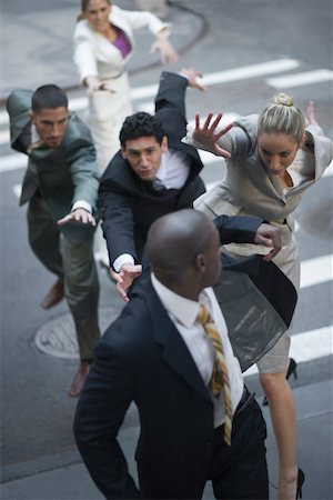 High angle view of business executives chasing a businessman Foto de stock - Sin royalties Premium, Código: 625-02267310