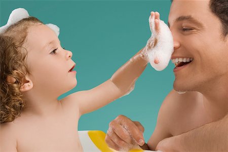 photo of young girl in bathtub - Close-up of a mid adult man playing with his daughter Stock Photo - Premium Royalty-Free, Code: 625-02267325